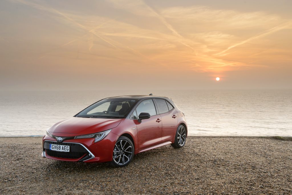 Red Toyota Corolla on the beach